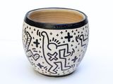 a black and white bowl with a design on it