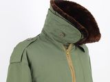 an image of a green jacket with a fur collar