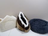 three pairs of slippers and a dog bed on the floor
