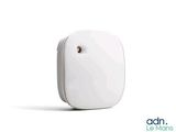 a close up of a small white device on a white surface