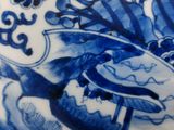 a blue and white plate with a bird on it