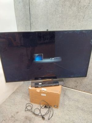 a flat screen tv sitting on top of a cardboard box