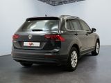 the back of a black volkswagen tiguan parked in a showroom