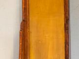 two wooden shelves on the wall with a mirror above them