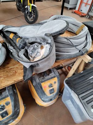 a pile of tools sitting on a table in a garage