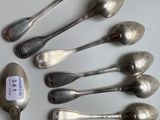 a lot of spoons that are sitting on a table