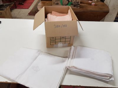 une boîte de serviettes pliées posée sur une table, à côté d'une autre boîte de serviettes pliées