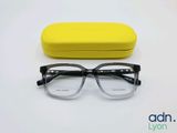 the glasses are next to a yellow case on a white surface
