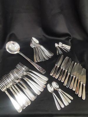 a lot of silver spoons and forks on the table