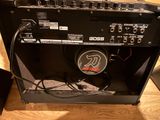 a guitar amp sitting on a wooden table