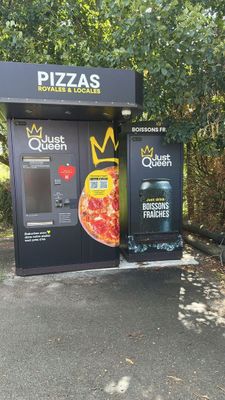 a vending machine that has a pizza on the front of it