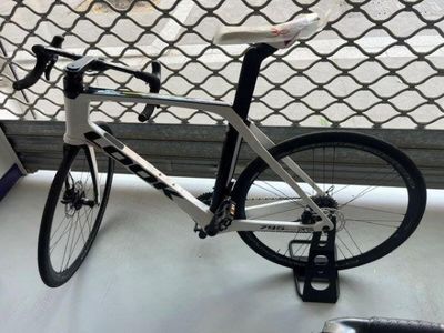 a bike that is sitting on a table in front of a fence