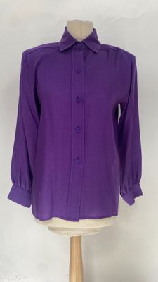 purple shirt on a mannequin stand with a white background