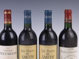 three bottles of red wine are lined up on a table