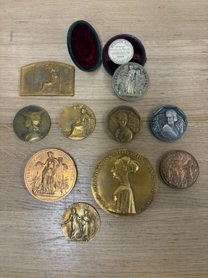 some of the medals are sitting on a wooden table