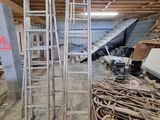 a room that has a ladder and a pile of wood in it