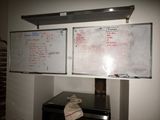 two dry erases on a white board on the wall