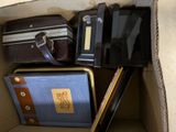 a cardboard box filled with various types of luggage