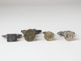 four different types of cuff rings on a white surface