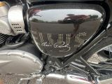 a close up of a motorcycle with a reflection of a person on it