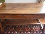 a wooden table with two drawers on top of it