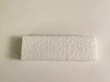a close up of a piece of white paper on a white surface