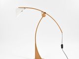 a wooden floor lamp with a white shade on top of it