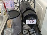 a coffee maker sitting on top of a counter next to a sink