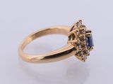 an 18k yellow gold ring with a sapphire and diamonds