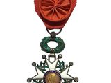 une image représentant une médaille ornée d'une étoile, suspendue à un ruban rouge