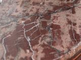 a close up of a marble counter top with a clock on it