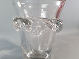 a glass vase with a toothbrush inside of it