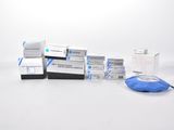 several boxes of blue and white medical supplies sitting on a white surface
