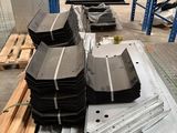 several pieces of metal are stacked on top of pallets in a warehouse
