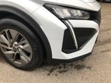 a close up of the front end of a white car