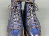 a pair of blue shoes with brown laces on them