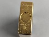 an image of a gold bar sitting on top of a white surface