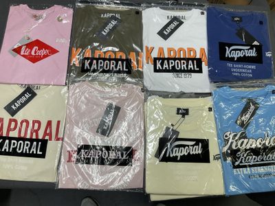 a lot of t - shirts that are on a table