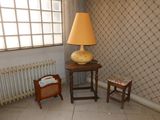 a lamp that is sitting on a table in the corner of a room