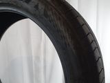 a close up of a tire on a table with a white background