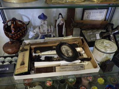 a glass shelf with a clock and various items on it