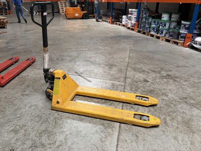 a forklift that is sitting on the floor in a warehouse