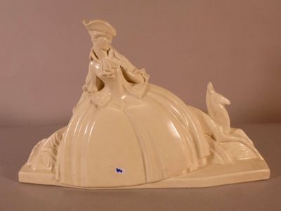 a figurine of a woman sitting on top of a pumpkin