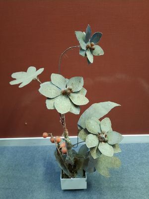 a small vase with flowers in it sitting on a table