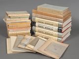 several old books stacked on top of each other on a table