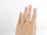 a woman ' s hand with a ring on it ' s finger