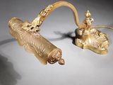 pair of gold - plated candlesticks and a candle holder