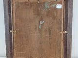 an old picture of a wooden frame with a piece of wood in it