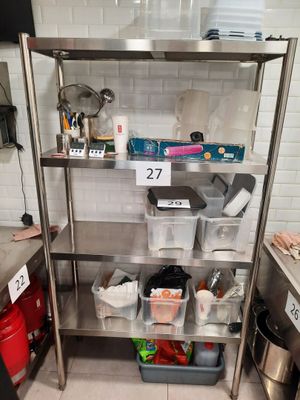 stainless steel shelvings with bins and containers on them in a kitchen