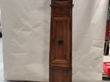a tall wooden grandfather clock sitting next to a small clock